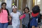 Children, some in tears, are escorted down a road in Barcelona, Spain, Thursday, Aug. 17, 2017. Police in Barcelona say a white van has mounted a sidewalk, struck several people in the city's Las Ramblas district. (AP Photo/Manu Fernandez)