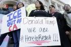 Protesters hold signs as they listen to speakers at a rally outside of City Hall in San Francisco, Wednesday, Jan. 25, 2017. President Donald Trump moved aggressively to tighten the nation's immigration controls Wednesday, signing executive actions to jumpstart construction of his promised U.S.-Mexico border wall and cut federal grants for immigrant-protecting "sanctuary cities." (AP Photo/Jeff Chiu)