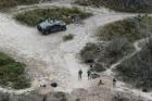 In this Feb. 24, 2015, file photo, members of the National Guard patrol along the Rio Grande at the Texas-Mexico border in Rio Grande City, Texas. (AP Photo/Eric Gay, File)