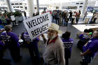 Demonstrators outside Tom Bradley International Terminal during a protest by airport service workers from United Service Workers West union on Jan. 30, 2017, at Los Angeles International Airport. The vigil is in support of travelers affected by the executive order restricting travel from seven primarily Muslim countries. (AP Photo/Chris Carlson)