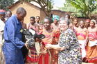With Veterinary Technician Jude's help, Sister Toni Temporiti, C.P.P.S., hands over a pregnant cow to Guadencia, a farmer in Masaka, Uganda, marking the beginning of her "living loan" in 2012. (Photo by Heather Cammarata)