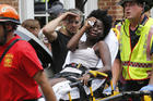 Rescue personnel help an injured woman after a car ran into a large group of protesters after an white nationalist rally in Charlottesville, Va., on Aug. 12. (AP Photo/Steve Helber)