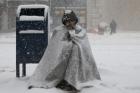 A homeless man asks for money during blizzard-like conditions Feb. 9 in in Boston (CNS photo/Brian Snyder, Reuters).