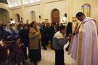 A priest gives Communion during Mass at a church in Baghdad March 1. Christian organizations have begun funneling aid to Syrian cities that are housing refugees from the Islamic State. (CNS photo/Ahmed Saad, Reuters)