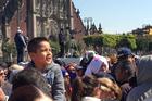 Watching Francis. A young boy with the crowd in Mexico City's historic Zocalo watches Pope Francis on a jumbo screen as he speaks to Mexico's bishops on Feb. 13. (Photo by Kevin Clarke)