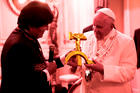 Bolivian President Evo Morales presents a gift to Pope Francis at the government palace in La Paz, Bolivia, July 8. The gift was a wooden hammer and sickle -- the symbol of communism -- with a figure of the crucified Christ. (CNS photo/L'Osservatore Romano/Illustration: America Media)