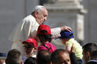 Pope Francis greets children during his general audience in St. Peter's Square at the Vatican, June 8 (CNS photo/Paul Haring). 