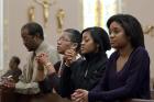 A family prays after arriving for Sunday Mass in 2011 at St. Joseph's Catholic Church in Alexandria, Va.