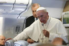 Pope Francis answers questions from journalists aboard his flight from Bangui, Central African Republic, to Rome Nov. 30 (CNS photo/Paul Haring).