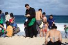 BEACH READING: A priest reads the Bible as he waits for the arrival of Pope Francis on Copacabana Beach during World Youth day in Rio de Janeiro on July 26.