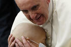 Pope Francis embraces a sick child during an audience with accountants in Paul VI hall at the Vatican Nov. 14. (CNS photo/Paul Haring)