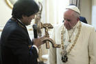 Bolivian President Evo Morales presents a gift to Pope Francis at the government palace in La Paz, Bolivia, July 8. The gift was a wooden hammer and sickle -- the symbol of communism -- with a figure of a crucified Christ. (CNS photo/L'Osservatore Romano)