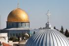 The silver dome of Our Lady of the Spasm Armenian Catholic Church and the golden Dome of the Rock rise over the Old City of Jerusalem. (iStock/rrodrickbeiler)