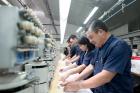 Workers at an embroidery factory (iStock/andresr)