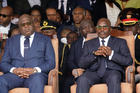 Congolese President Felix Tshisekedi, left, and outgoing president Joseph Kabila sit side by side during the inauguration ceremony in Kinshasa, Democratic Republic of the Congo on Jan. 24, 2019. (AP Photo/Jerome Delay)