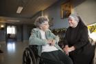 Sister Michael Mugan visits Jan. 13 with resident Pat Austin in the hallway of the St. Louis Residence of the Little Sisters of the Poor, which serves about 100 people. (CNS photo/Lisa Johnston, St. Louis Review)