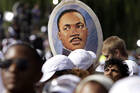 A woman holds a portrait of the Rev. Martin Luther King Jr. at the Oct. 16 dedication of a memorial to Rev. King in Washington. The memorial commemorates the life and work of the late civil rights leader. (CNS photo/Yuri Gripas, Reuters)