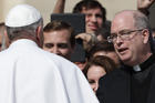 Pope Francis greets Father Robert W. Oliver, secretary of the Pontifical Commission for the Protection of Minors, during general audience in St. Peter's Square.