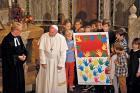 CLOSER TOGETHER Pope Francis receives a gift from children during a visit to Christuskirche, a parish of the German Evangelical Lutheran Church in Rome, on Nov. 15, 2015