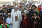 Pope Francis walks with Bolivian President Evo Morales and children in traditional dress as he arrives at El Alto International Airport in La Paz, Bolivia, July 8 (CNS photo/Paul Haring).