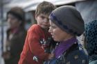 A young Syrian mother and her child in 2015 outside their tent at an informal settlement in Deir al Ahmar, in Lebanon's Bekaa Valley (CNS photo/Sam Tarling, CRS). 