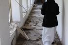 A nun walks through the hallway of the badly damaged convent of the Dominican Sisters of St. Catherine of Siena in Qaraqosh, Iraq. (CNS photo/courtesy John E. Kozar, CNEWA)