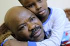 Sudanese activist Tayeb Ibrahim, who had worked to expose Sudanese abuses in the volatile South Kordofan province and hopes to see family living in the U.S. state of Iowa, is hugged by his son Mohammed during an interview with The Associated Press in Cairo, Egypt, on June 28, 2017. (AP Photo/Amr Nabil)