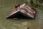 Children swim in a swollen river on Samar Island, Philippines, Dec. 8. Typhoon Hagupit left at least 21 people dead and forced more than a million people into shelters (CNS photo/Francis R. Malasig, EPA).