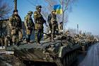 IDENTITY CRISIS. Ukrainian armed forces ride on armored personnel carriers near Debaltseve, Ukraine, Feb. 12.